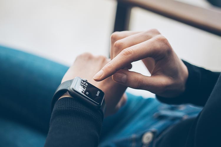 Hands using a smart watch